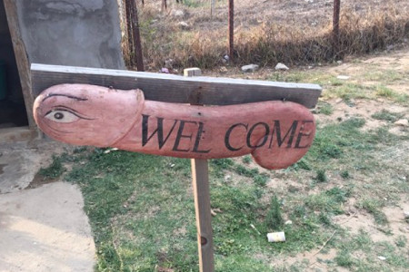 Welcome sign carved in the shape of a penis