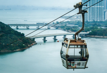 A cable car rising way over a river scene in Hong Kong