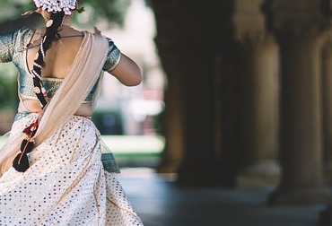 The back of an Indian woman in a saree