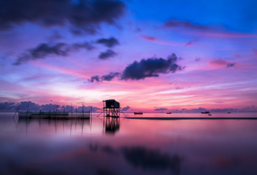 A calm scene of a sunset over a river